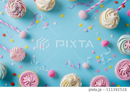 Blue table top on blue background with decorated lollipops and cupcakes, children birthday party 111392528