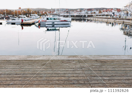 Old wooden pier. Many yachts and boats are moored at the pier. Boating and rest on the yacht. Vacation at sea. Selective focus. 111392626