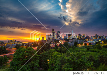 Dramatic sunset over Seattle skyline with highway in foreground 111392817