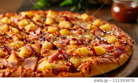 A Hawaiian pizza with pineapple, ham, and a drizzle of sweet barbecue sauce 111393670