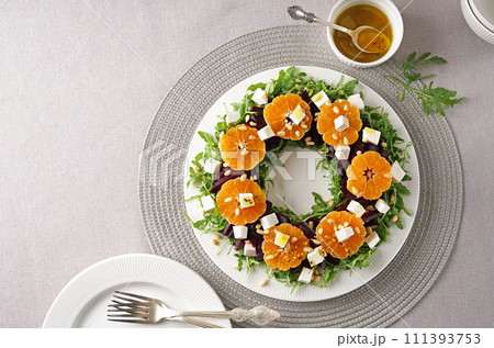 Beet, cheese and tangerine healthy salad with arugula, white kitchen table, copy space. 111393753