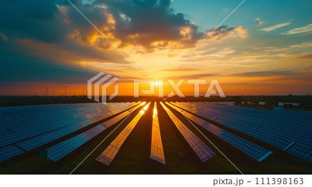 The sun rises, casting a golden glow over an extensive array of solar panels amidst a desert landscape. The sun rises, casting a golden glow over an extensive array of solar panels amidst a desert landscape. 111398163