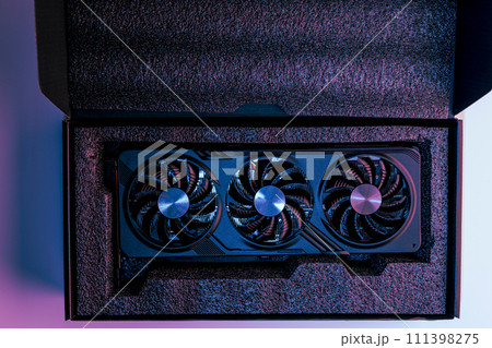 video card for a computer with three fans lies in holders in the shipping box 111398275