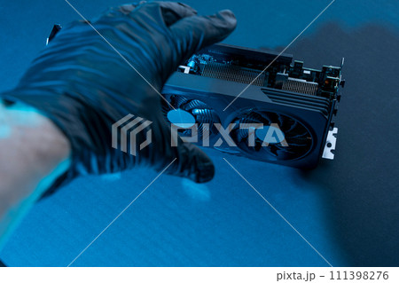 hand of a computer technician holds a modern powerful video game card hand of a computer technician holds a modern powerful video game card 111398276