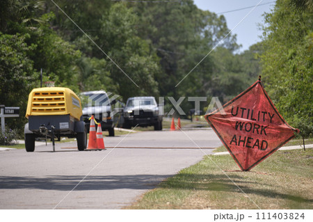 Road work ahead sign on street site as warning to cars about construction and utility works Road work ahead sign on street site as warning to cars about construction and utility works 111403824
