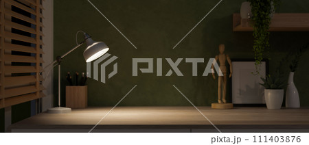 A copy space on a hardwood table with dim light from a table lamp, in a dark home office room. A copy space on a hardwood table with dim light from a table lamp, in a dark home office room. 111403876