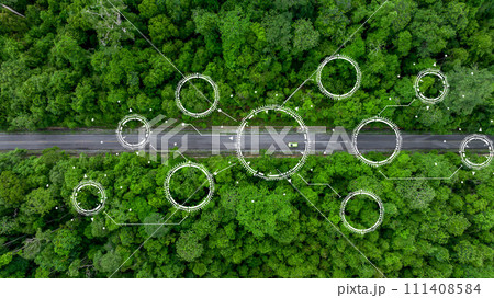 Aerial top view of green electric vehicle car driving over straight forest road, EV car electric vihicle car on forest road with globe green energy and eco power produced from sustainable. 111408584