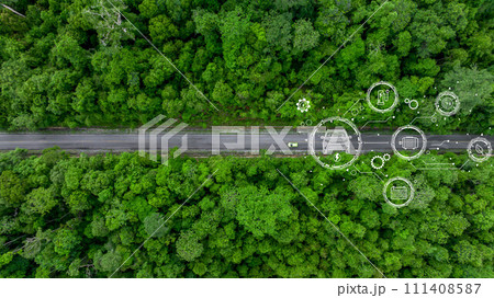 Aerial top view of green electric vehicle car driving over straight forest road, EV car electric vihicle car on forest road with globe green energy and eco power produced from sustainable. 111408587