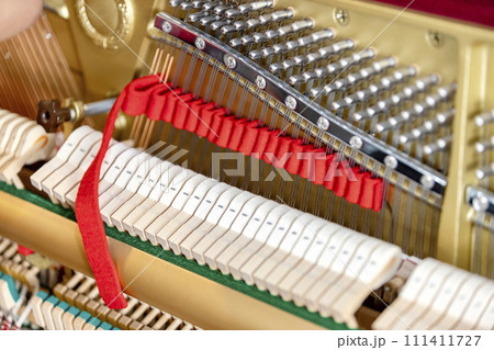 Shallow focus close-up of tools for tuning the internal mechanisms of an upright piano. Gives a feeling of luxury, classic, luxury, grandeur. Pictures can be used on various topics related to music. Shallow focus close-up of tools for tuning the internal mechanisms of an upright piano. Gives a feeling of luxury, classic, luxury, grandeur. Pictures can be used on various topics related to music. 111411727