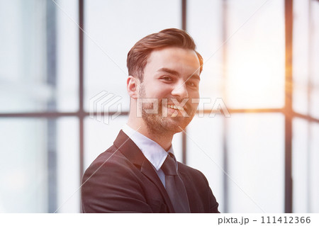 Portrait of a happy man wearing glasses and looking at the camera indoors. 111412366