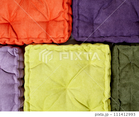 Arranged colorful velour cushions for cosy stylish interior design 111412993