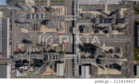 Aerial top view Oil and Gas refinery petrochemical plant industrial with oil and gas storage tank. White oil and gas refinery storage tank. Aerial view oil and gas refinery plant from industrial zone. 111414427