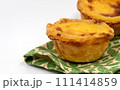 Lots of freshly baked desserts Pastel de nata or Portuguese egg tart. Pastel de Belm is a small pie with a crispy puff pastry crust and a custard cream filling. A small dessert, a cupcake 111414859