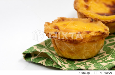 Lots of freshly baked desserts Pastel de nata or Portuguese egg tart. Pastel de Belm is a small pie with a crispy puff pastry crust and a custard cream filling. A small dessert, a cupcake 111414859