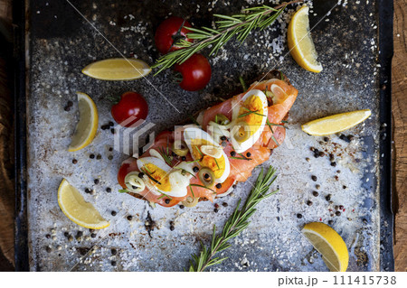 Salted salmon open sandwich with eggs, tomatoes, olives, cream cheese, cucumber and garlick. Healthy seafood. Top view 111415738