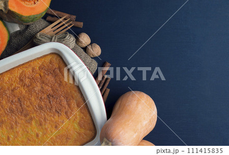 Pumpkin. Sugar-free pumpkin cake, honey, oatmeal in a baking dish on a dark table. Healthy food Pumpkin. Sugar-free pumpkin cake, honey, oatmeal in a baking dish on a dark table. Healthy food 111415835