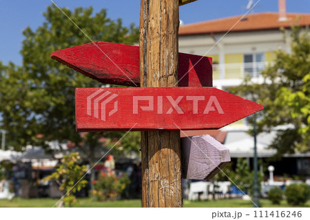 Wooden arrow sign post. Empty boards for your text 111416246