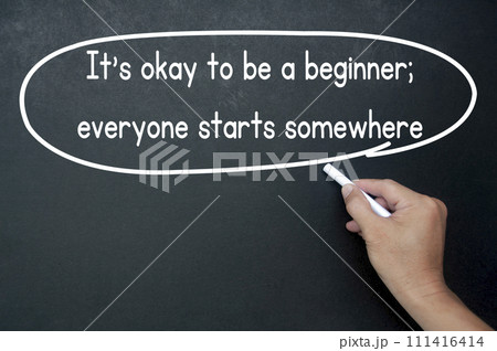 Hand writing It is okay to be a beginner affirmation on black board. Affirmation concept. Hand writing It is okay to be a beginner affirmation on black board. Affirmation concept. 111416414