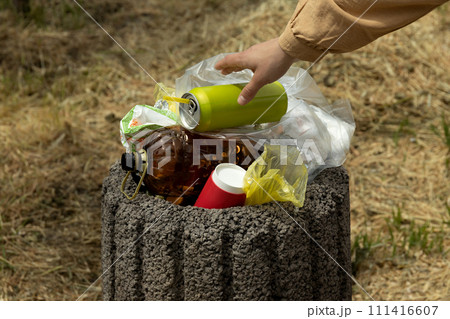 An overflowing garbage can on the street. 111416607