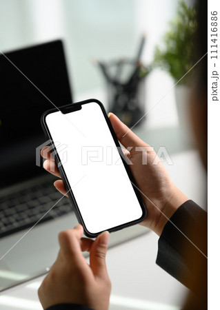 Closeup businesswoman using smartphone at office desk. Blank screen for advertising 111416886
