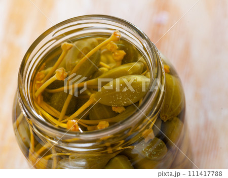 Glass jar with pickled green capers Glass jar with pickled green capers 111417788