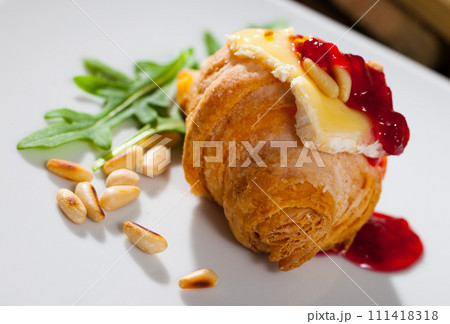 Croissant with camembert, jam and pine nuts Croissant with camembert, jam and pine nuts 111418318