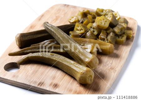 Natural Okra slices on cutting board isolated on white background Natural Okra slices on cutting board isolated on white background 111418886