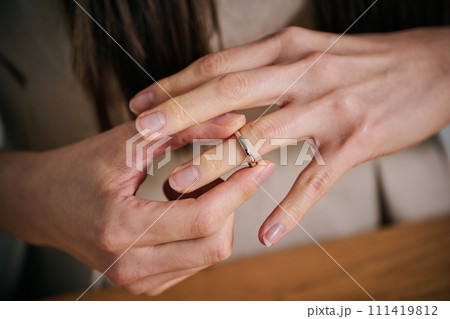 結婚指輪を外す女性の手 111419812
