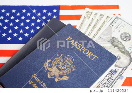 US passport with dollar money on USA flag, American citizen in United States of America. US passport with dollar money on USA flag, American citizen in United States of America. 111420584