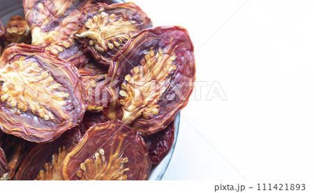 Dried tomatoes on a white background with space for text. Food 111421893