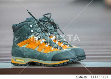 A pair of leather trekking hiking winter boots on blurred background A pair of leather trekking hiking winter boots on blurred background 111422593
