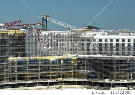Aerial view of ruined by hurricane Ian construction crane on high apartment building site in Port Charlotte, USA 111422900