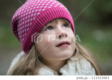 Pretty child girl in warm knitted winter clothes outdoors. Pretty child girl in warm knitted winter clothes outdoors. 111423063