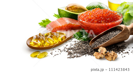 Fish oil capsules in wooden spoon and food rich in omega 3 fatty acids on white background. Fish oil capsules in wooden spoon and food rich in omega 3 fatty acids on white background. 111423843