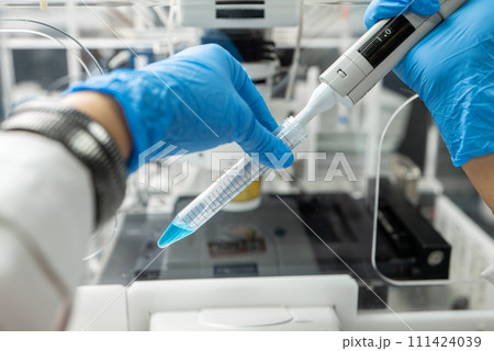 Dripping liquid from pipette into test tube in laboratory, closeup Dripping liquid from pipette into test tube in laboratory, closeup 111424039