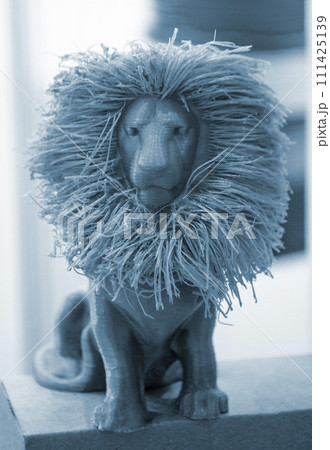 Art object model of lion printed on 3D printer. Lion toy created by 3D printing from molten plastic. Example of creating prototype by 3D printer. Concept 3D printing. Printing innovation technology Art object model of lion printed on 3D printer. Lion toy created by 3D printing from molten plastic. Example of creating prototype by 3D printer. Concept 3D printing. Printing innovation technology 111425139
