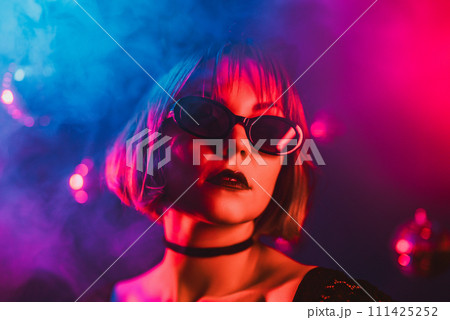 Portrait of young pretty woman neon light. Pussy cat costume for halloween party Portrait of young pretty woman neon light. Pussy cat costume for halloween party 111425252