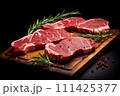 Fresh raw meat steaks on cutting board on dark background 111425377