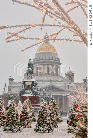 Russia, St Petersburg, St. Isaac's Cathedral and the monument to Emperor Nicholas II through lighting decorations during snowstorm, streets decorated for Christmas Russia, St Petersburg, St. Isaac's Cathedral and the monument to Emperor Nicholas II through lighting decorations during snowstorm, streets decorated for Christmas 111426438