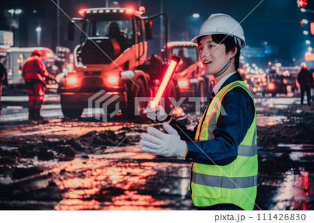 道路で交通整理をする警備員 111426830