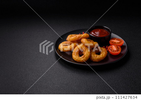 Delicious nutritious squid or onion rings deep fried with salt and spices 111427634