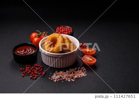 Delicious nutritious squid or onion rings deep fried with salt and spices 111427651