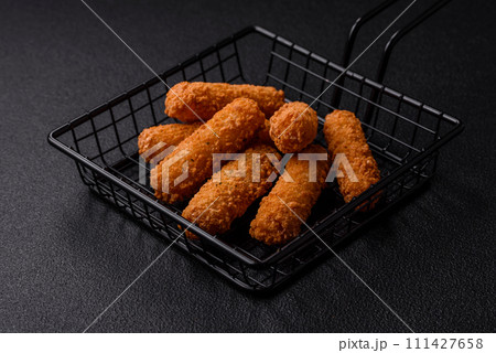 Delicious crispy cheese sticks with mozzarella, salt and spices Delicious crispy cheese sticks with mozzarella, salt and spices 111427658