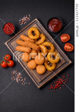 Delicious nuggets, rings and balls of mozzarella and parmesan cheese with salt and spices 111427750