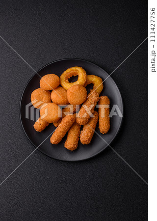 Delicious nuggets, rings and balls of mozzarella and parmesan cheese with salt and spices 111427756