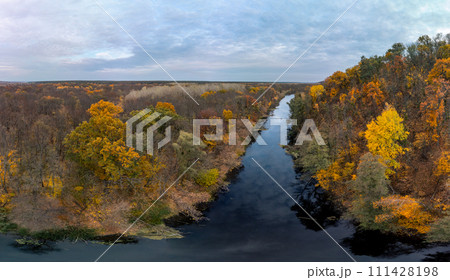 Autumn colorful forest on river with epic clouds 111428198