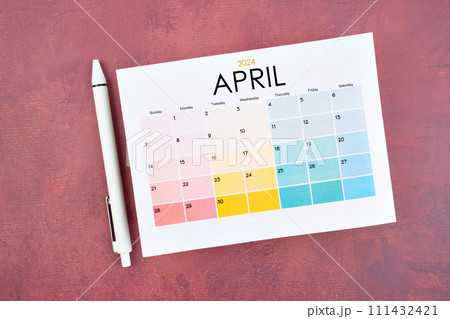 April 2024 calendar page and pen on red retro background. April 2024 calendar page and pen on red retro background. 111432421