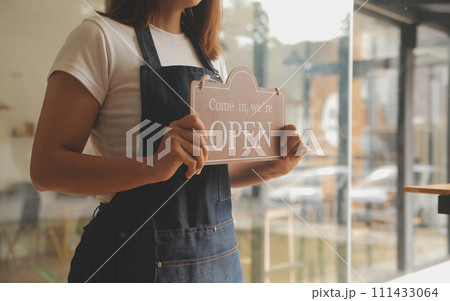 Startup successful small business owner sme beauty girl stand with tablet smartphone in coffee shop restaurant. Portrait of asian tan woman barista cafe owner. SME entrepreneur seller business concept Startup successful small business owner sme beauty girl stand with tablet smartphone in coffee shop restaurant. Portrait of asian tan woman barista cafe owner. SME entrepreneur seller business concept 111433064