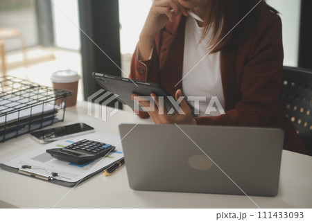 Shot of a asian young business Female working on laptop in her workstation. Shot of a asian young business Female working on laptop in her workstation. 111433093