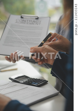 Business Signing a Contract Buy - sell house, insurance agent analyzing about home investment loan Real Estate concept. Business Signing a Contract Buy - sell house, insurance agent analyzing about home investment loan Real Estate concept. 111433143